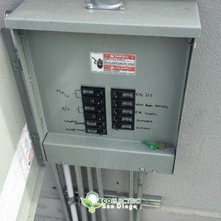 Electrical panel box open with key resting on panel