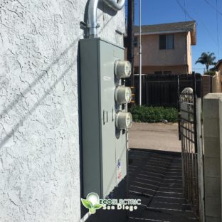 3 Electrical submeters installed on the side of a building