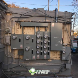 Multiple electrical submeters on the side of a building