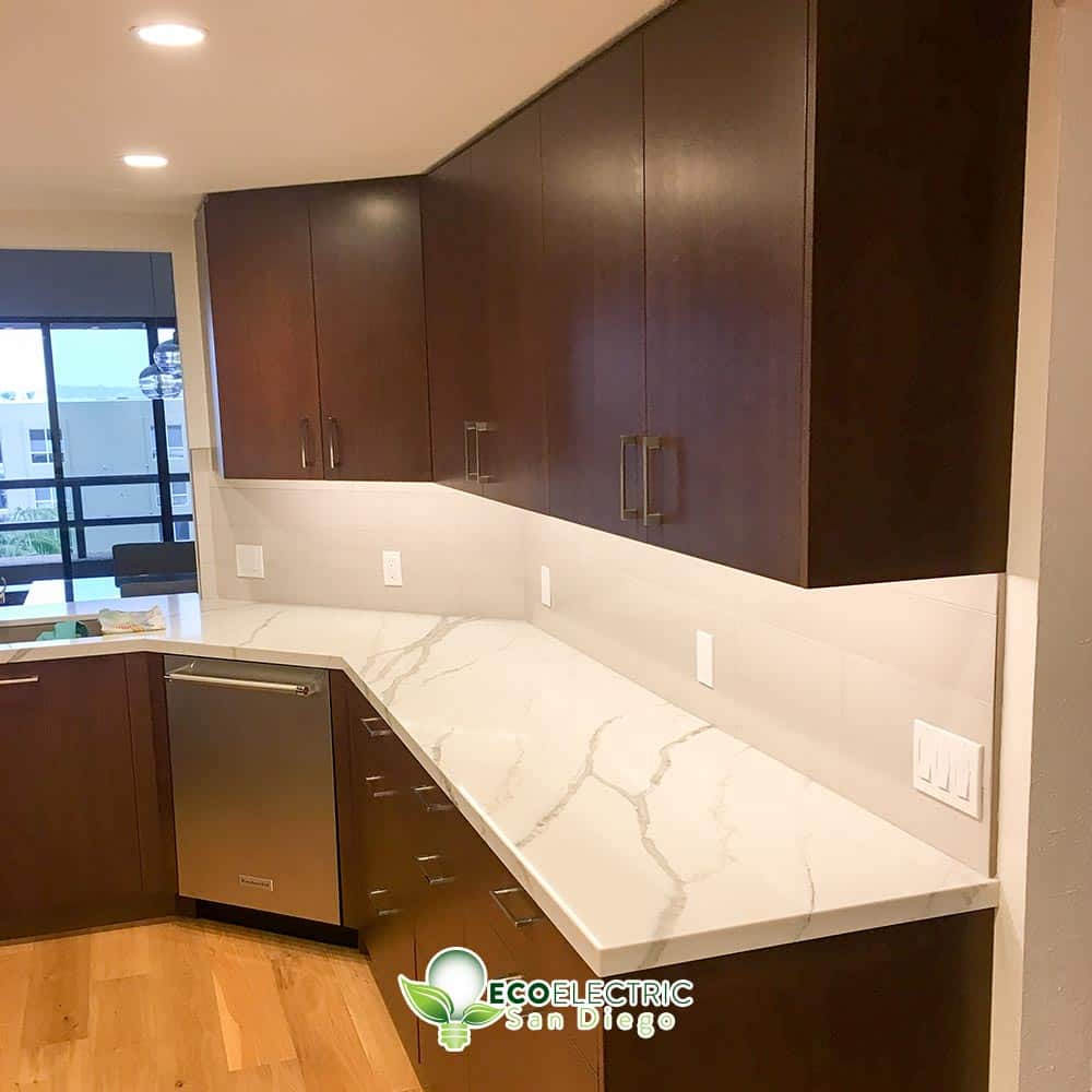 Brown and white kitchen with recessed lighting under cabinets