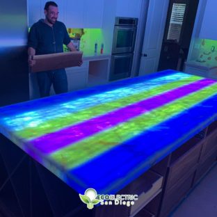 Man watches an underlit countertop lightshow